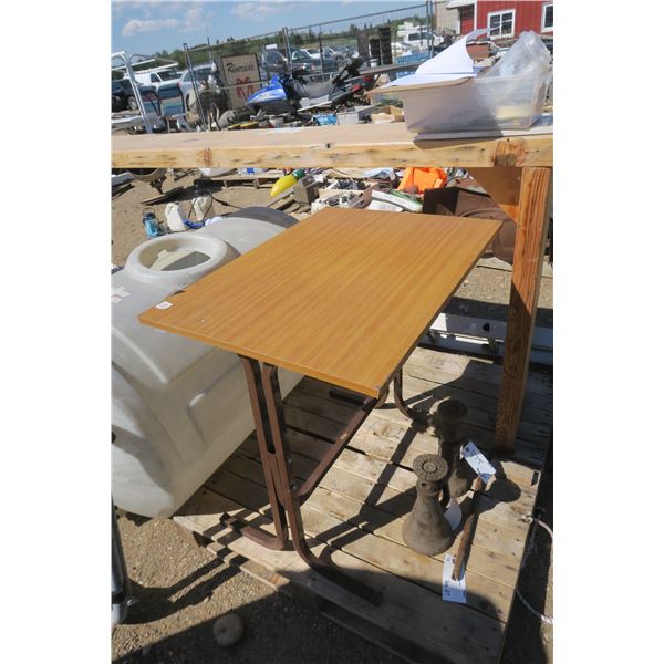 Brown drafting table with tilt top.