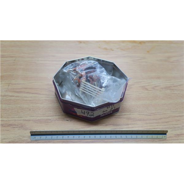 tin of plastic animals.