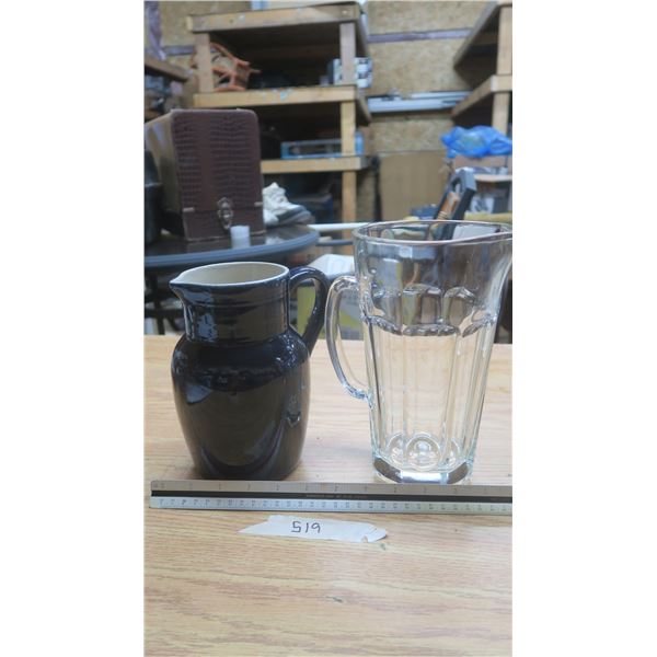 2- pitchers.  1-black ceramic,  large glass pitcher.