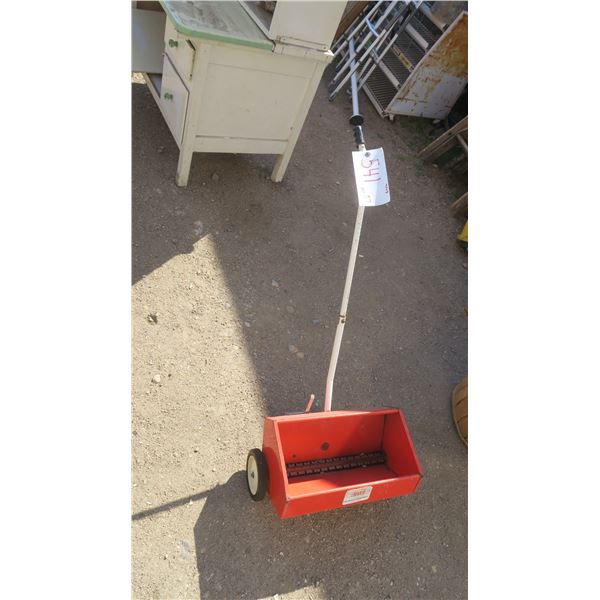 red metal seed spreder.