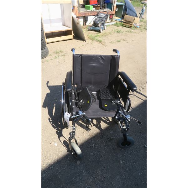 Black wheelchair with foor rest.