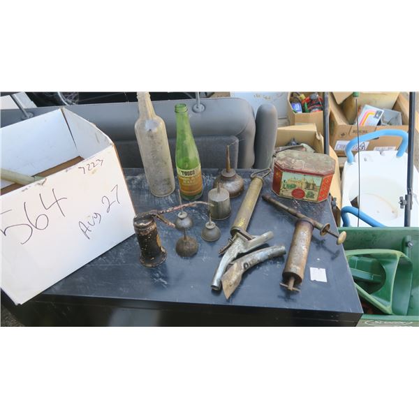 box of misc antique items , old tin filled with fittings, oiler cans, pumps.