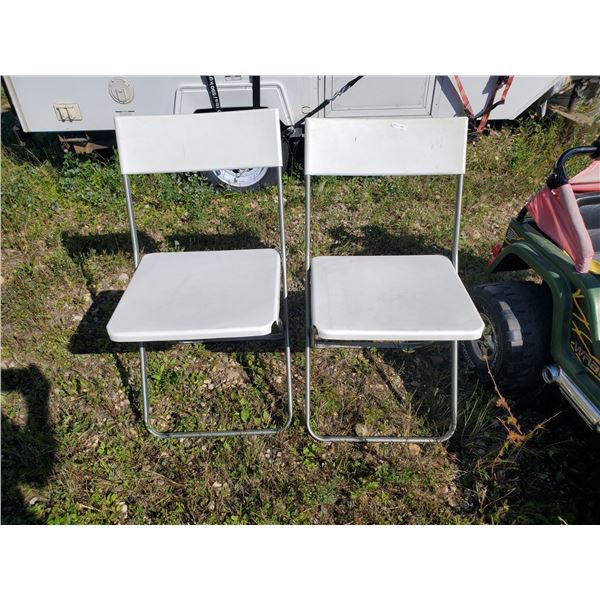 2 white collapsible chairs