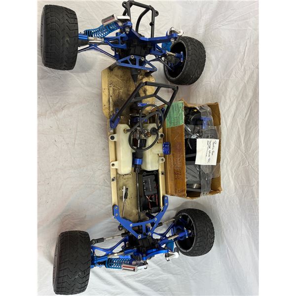 partially assembled Gasoline RC car and box of parts