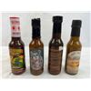 Image 4 : Four mixed unopened bottles of hot sauce