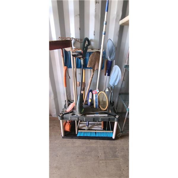 GARDEN IMPLIMENT RACK FULL OF GARDENING TOOLS: AXE, SHOVEL, RAKE, EDGE TRIMMER, BROOM PSI