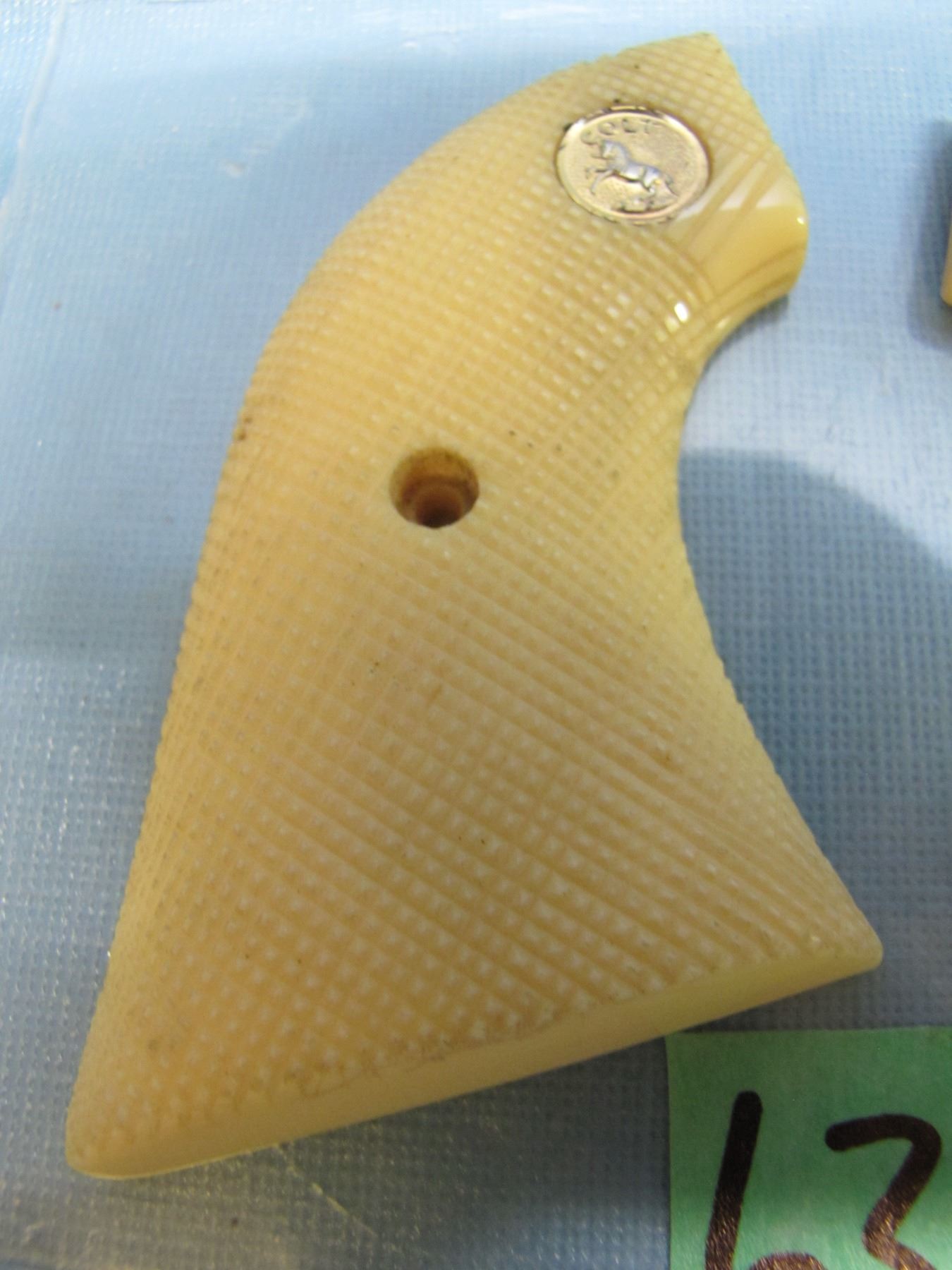 Pair of colt 1873 single action army pistol grips ; colt emblem ; Ivory