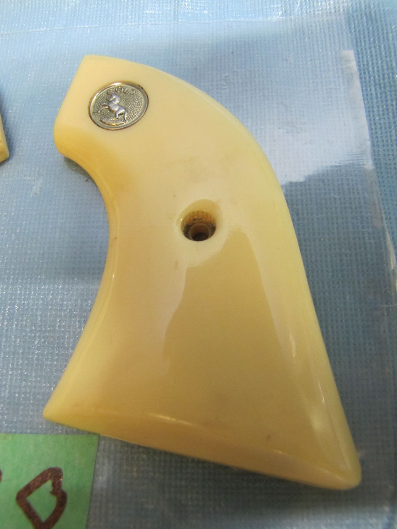 Pair of colt 1873 single action army pistol grips ; colt emblem ; Ivory