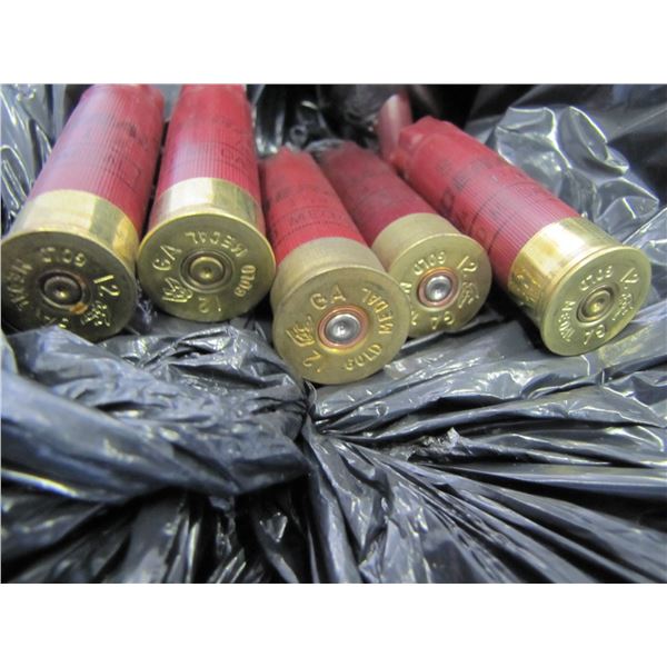 Lot of 12 gauge shotgun shell hulls; in a plastic garbage bag estimate about half a 45 gallon drum s