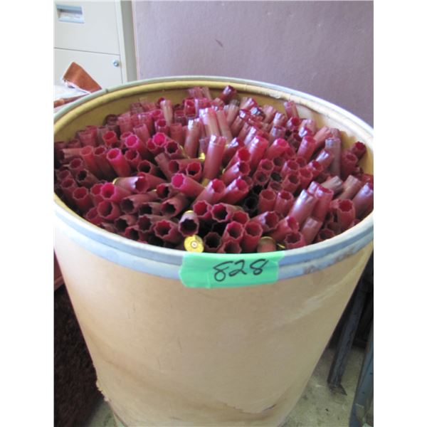 Lot of 12 gauge shotgun shell hulls in a paper barrel 21 inches tall by 19 inches round
