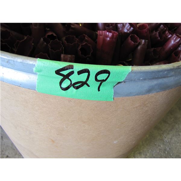 Lot of 12 gauge shotgun shell hulls in a paper barrel 21 inches tall by 19 inches round