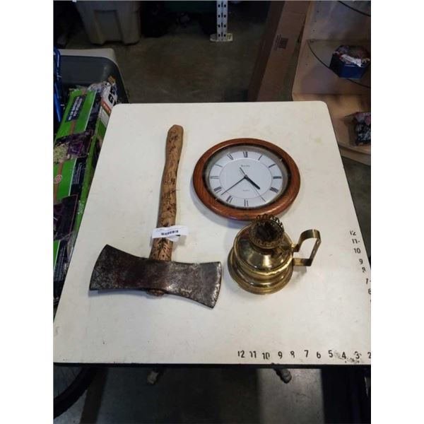 DOUBLE HEADED AXE WITH CARVED HILT, BULOVA WALL CLOCK AND BRASS OIL LAMP