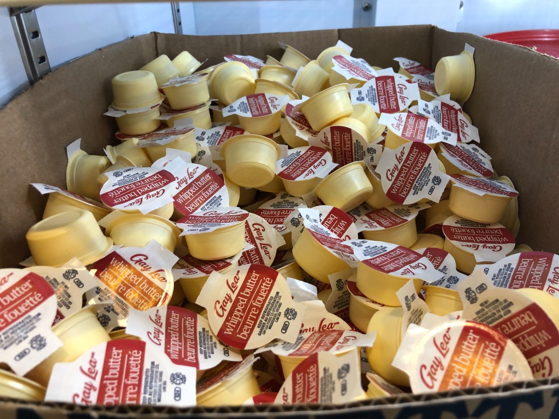 Box full of mini Gay Lea whipped butter packets (approx. 100+ pieces)