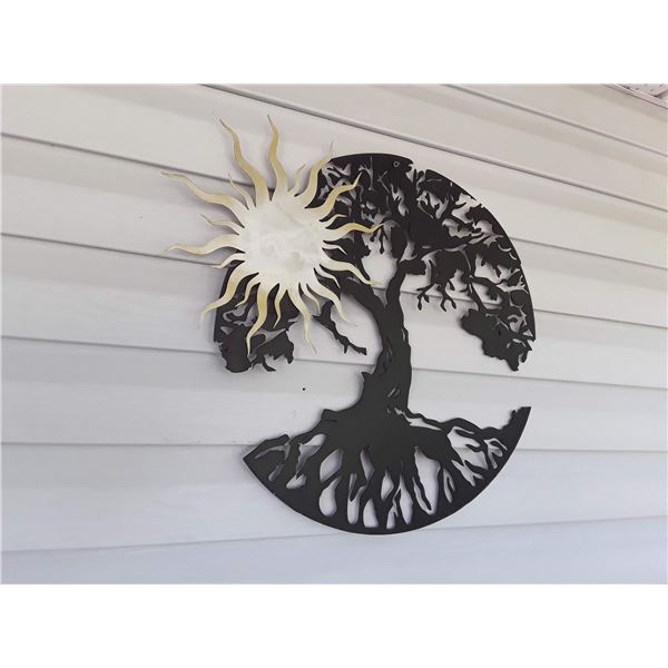 Metal wall hanging of sun and tree