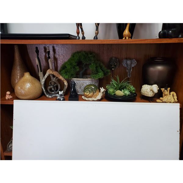 Shelf of clay bases stone carvings and more