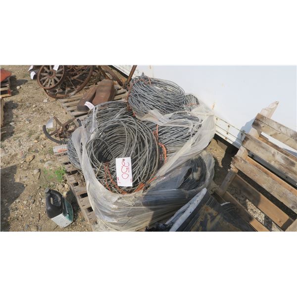 pallet with rolls of used smooth braded fence wire.