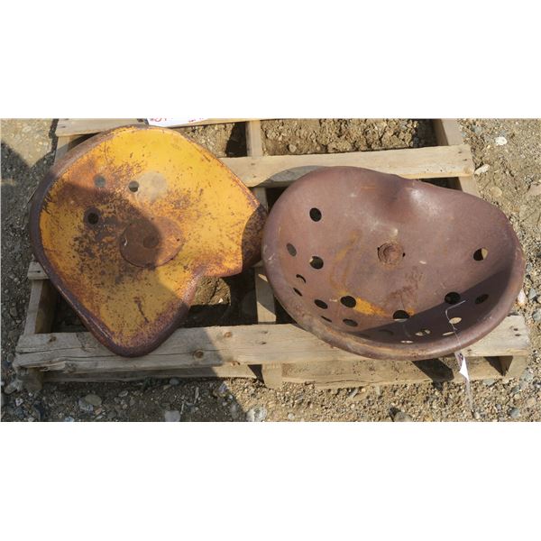 2 antique metal tractor seats with vent holes