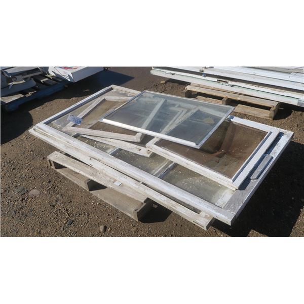 Pallet of older wooden framed windows, various sizes.