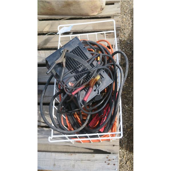 white metal basket of cables, work light, battery charger