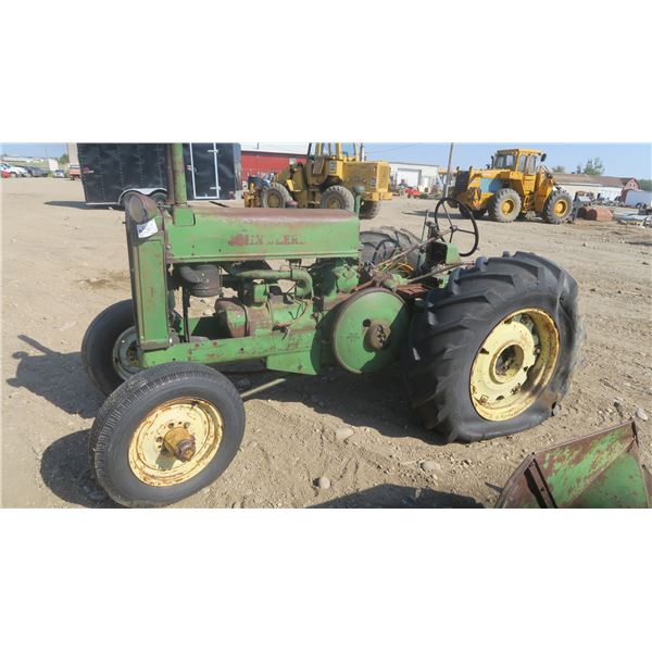 Model A John deer tractor #269444 with pallet of fenders and items for tractor.