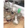 Image 2 : "Motherland: Fort Salem" - Group of assorted alcohol glass bottles