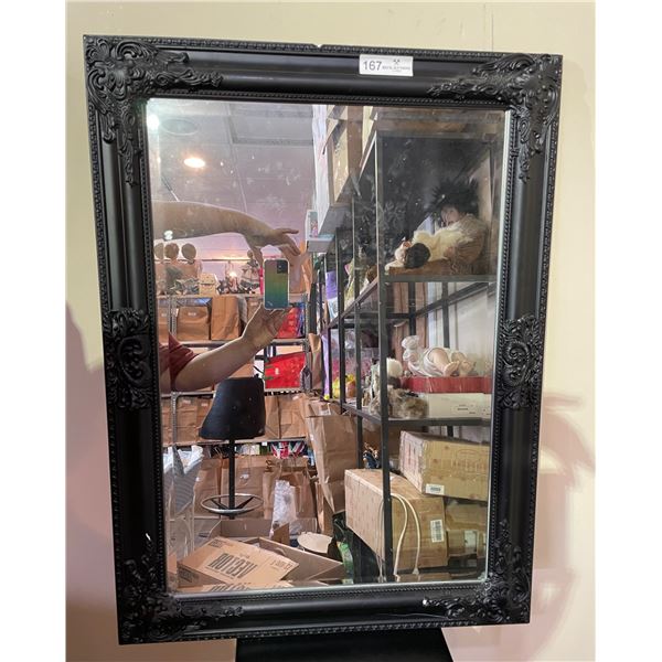 Mirror with ornate black frame