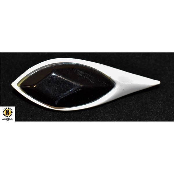 WHITE PLASTIC W BLACK GLASS BROOCH