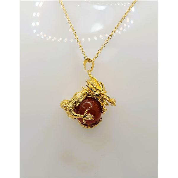 26)  GOLD TONE DRAGON HOLDING A  CHERRY