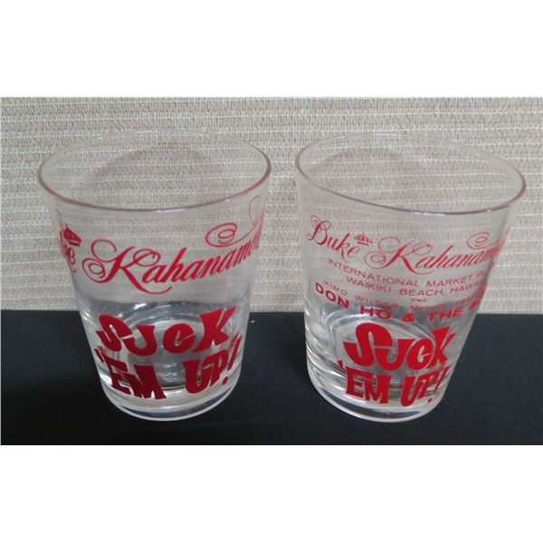 Qty 2 Duke Kahanamoku Glasses: Suck 'em Up & International Marketplace 4.5"H