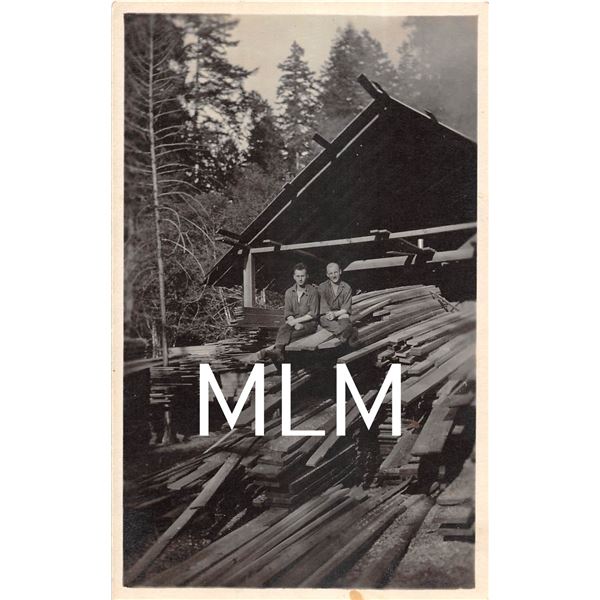 Two Men On Wood Pile at Lumber Mill Photo Postcard