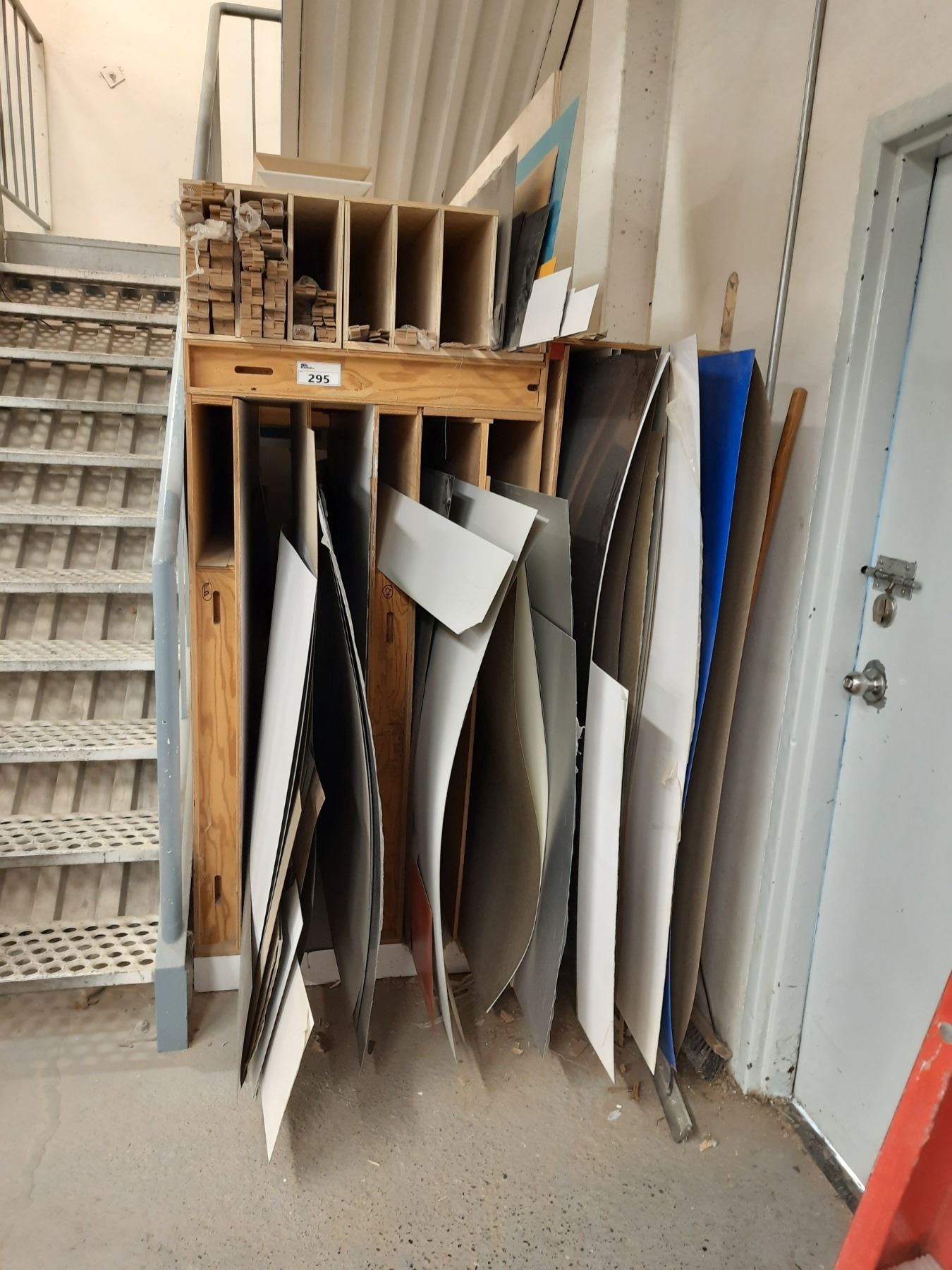 CONTENTS OF VENEER & SHIMS LOCATED IN RACKS UNDER THE MEZZANINE STAIRS
