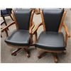 Image 1 : SHOWROOM PAIR OF CALIFORNIA HOUSE ROLLING PARLOUR CHAIRS; BLACK STUDDED/ LIGHT BROWN WOOD FINISH