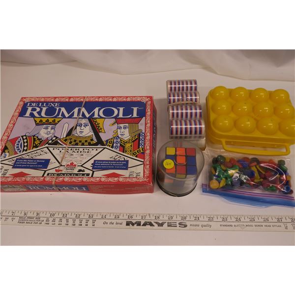 Rummoli, puzzle cube, poker chips, assorted game pieces, egg carrier