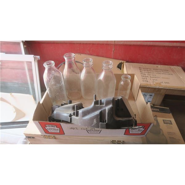 box of vintage glass milk bottles and car part