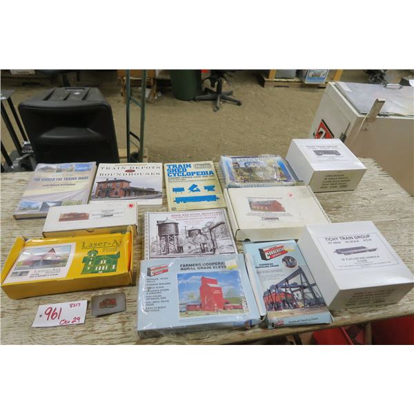 Box lot of model train set building kits, tracks and books