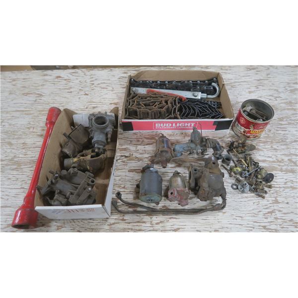 Assorted carburetors, Assorted chains, Red socket wrench