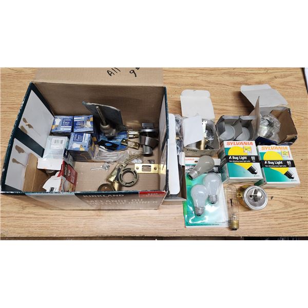 Box of Assorted hardwares - Light bulbs, Dead bolts and a Sink drain