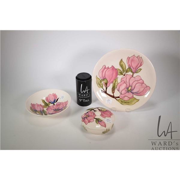 Three pieces of Moorcroft Magnolia glazed pottery including 5" lidded dresser jar, 10" charger and a