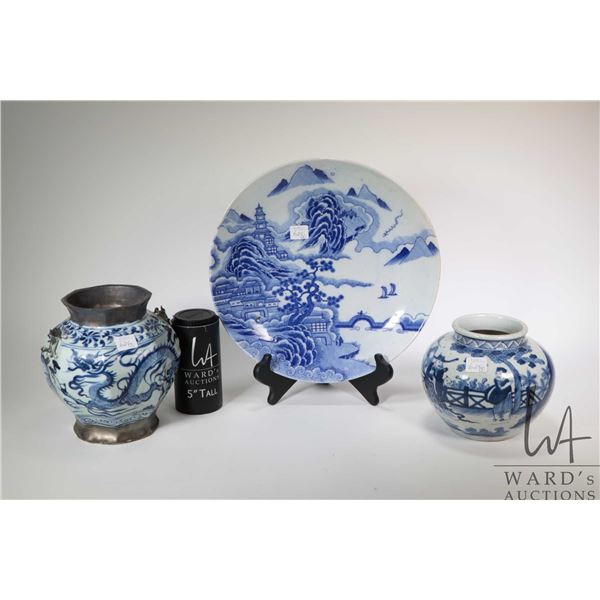 Three pieces of Oriental blue and white pottery including 12" charger, dragon motif bowl with applie