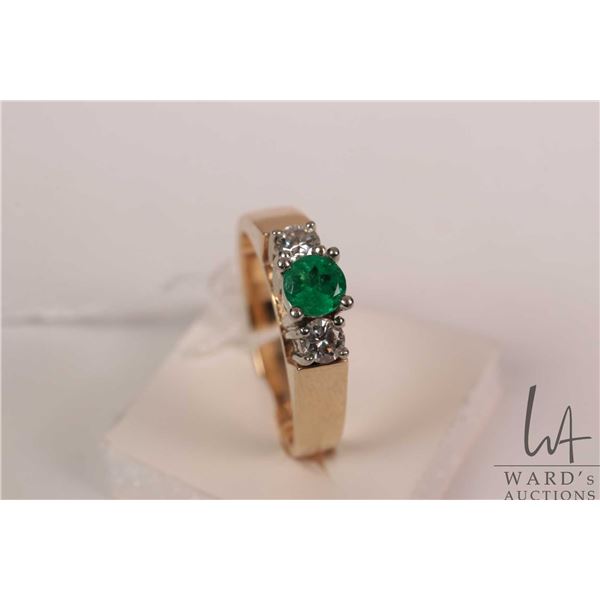 14kt yellow gold with white gold setting emerald and diamond gemstone ring. Set with .35ct round mix