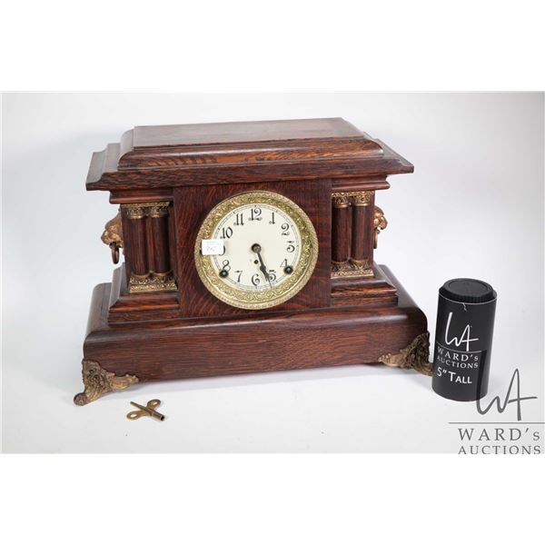 Quarter cut oak cased Arthur Pequegnant chiming mantle clock with decorative column design, gilt fac