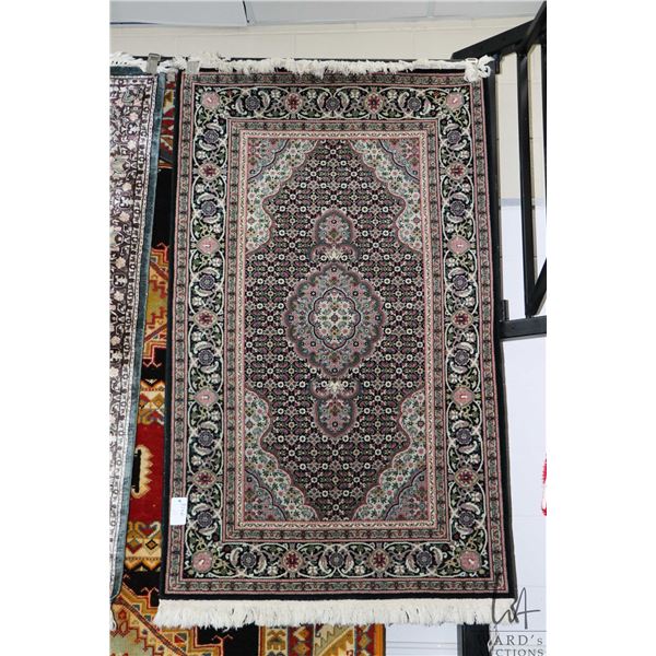 Quality fine weave wool area carpet with center medallion and delicately detailed floral design in c