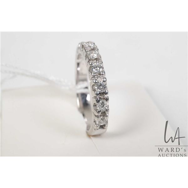 14kt white gold and diamond ring, set with seven round brilliant cut white diamonds. Total diamond w