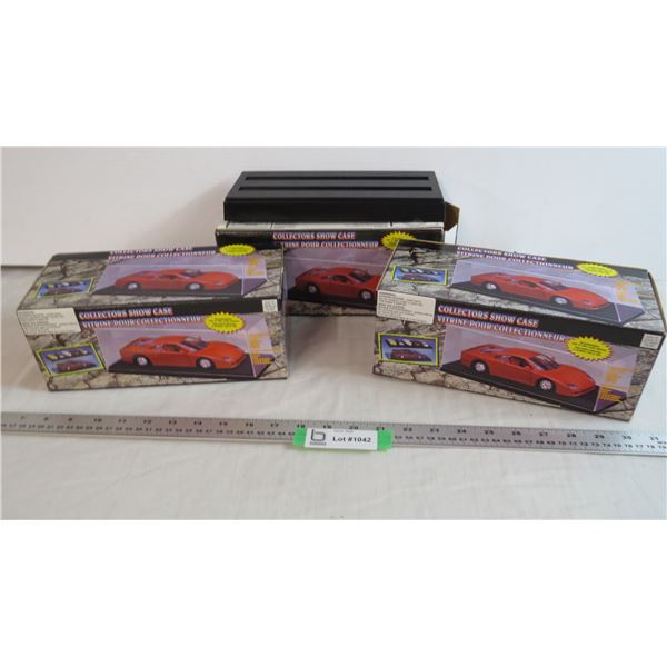 (2) sealed Collectors Showcases, 1 showcase base and box