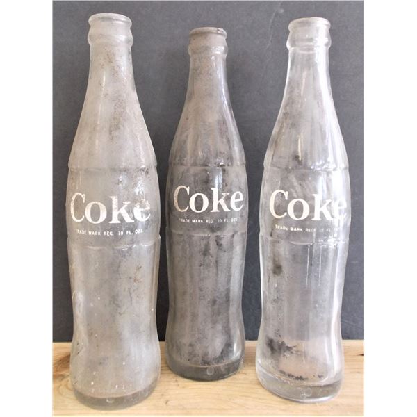 Three Vintage Coca-Cola Bottles