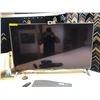 Image 2 : LG 49 inches Smart TV model 49UN73OOAUD, a Logitech mouse and keyboard, and a Logitech webcam