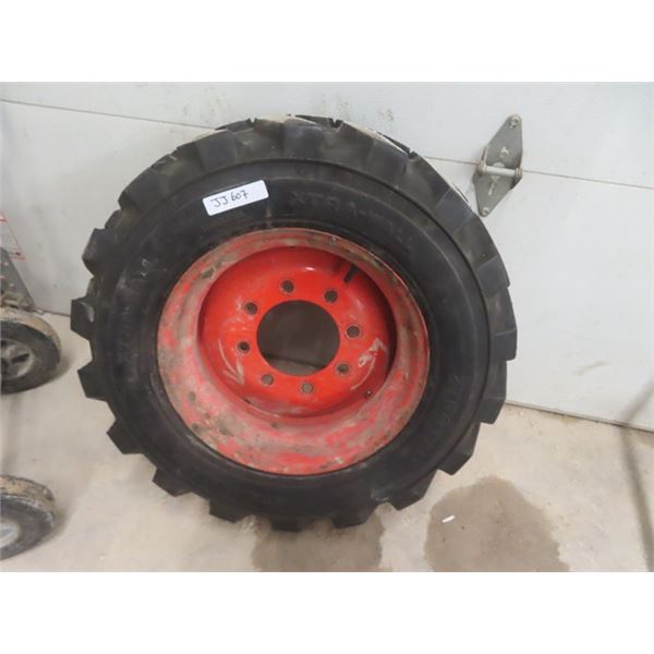 Skid Steer Tire Mounted on 8 Bolt Rim - 10 - 16.5 Extra Wall - like new