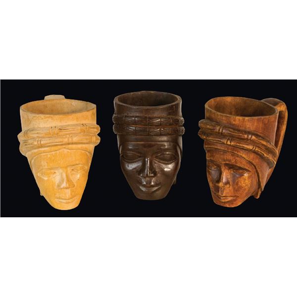 SET OF THREE CARVED FIGURAL HEAD CUPS.
