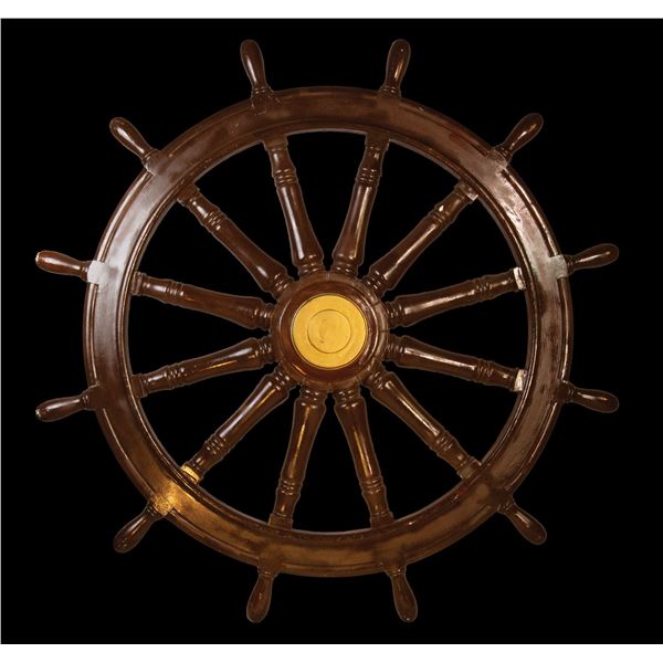 FIBERGLASS SHIPS WHEEL FROM THE OCEANIC ARTS LUAU RENTAL DEPARTMENT.