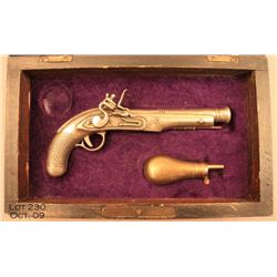 Cased silver miniature of a cannon barreled  flintlock pistol, approx. 5-1/2” overall, in  overall f